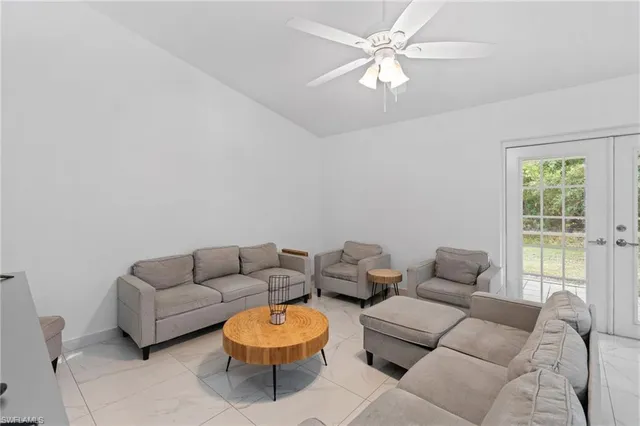 a bedroom with a bed and a flat tv screen on the dresser