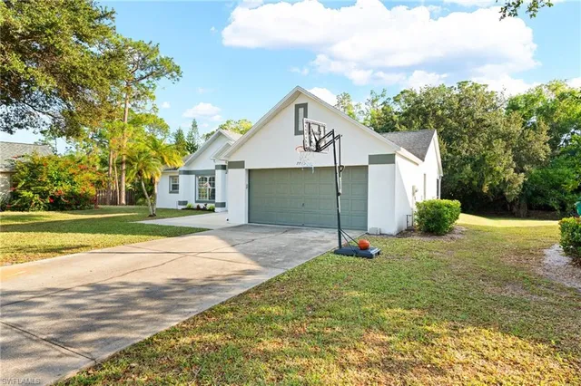 a view of a house with a yard and garage