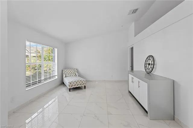 a large white kitchen with cabinets and stainless steel appliances