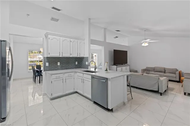 a kitchen with cabinets and steel stainless steel appliances