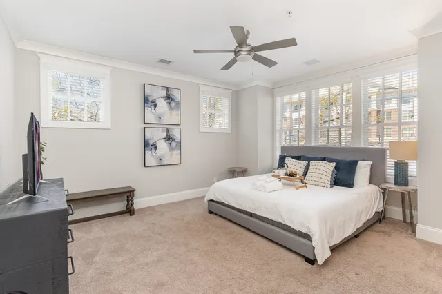 a bedroom with a bed and a chandelier