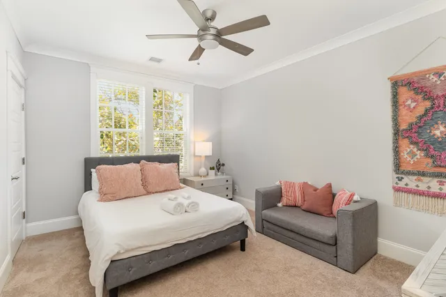 a bedroom with a bed couch and window