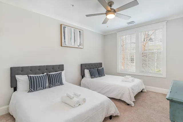 a bedroom with two beds and a window