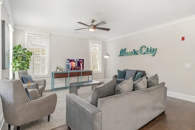 a living room with furniture and a potted plant