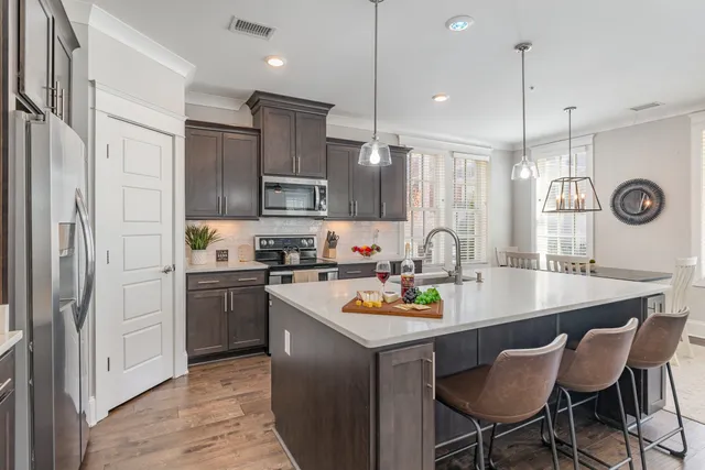 a kitchen with refrigerator cabinets and stove