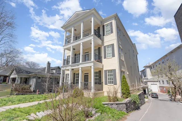 a front view of a building with a garden