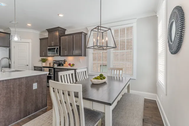 a kitchen with stainless steel appliances granite countertop a sink and a refrigerator