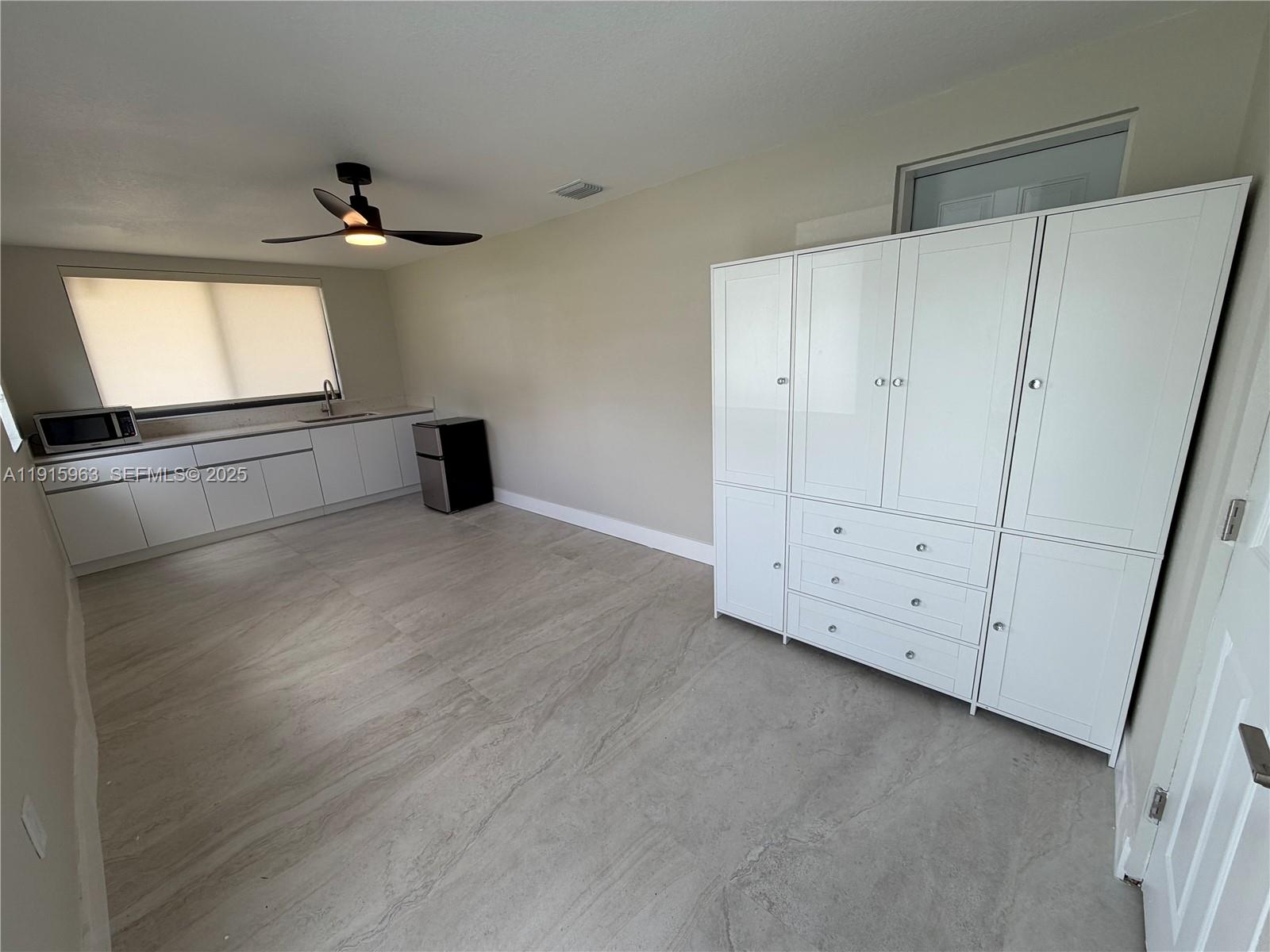 7330 Southwest 11th Street, Unit EFFICIENCY Miami, FL 33144 - Photo 2 of 11 a view of an empty room with a window