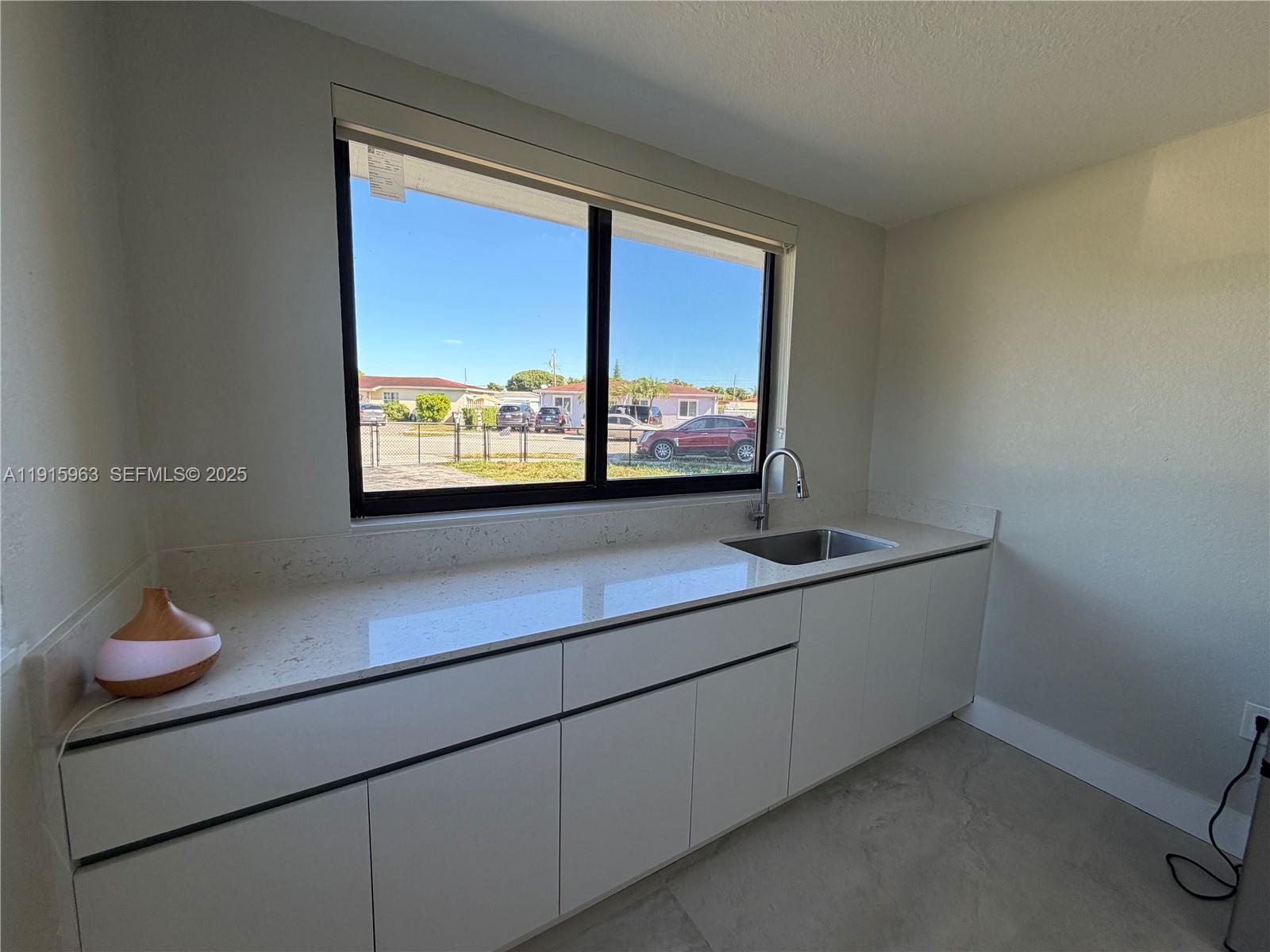 7330 Southwest 11th Street, Unit EFFICIENCY Miami, FL 33144 - Photo 7 of 12 a room with a large window