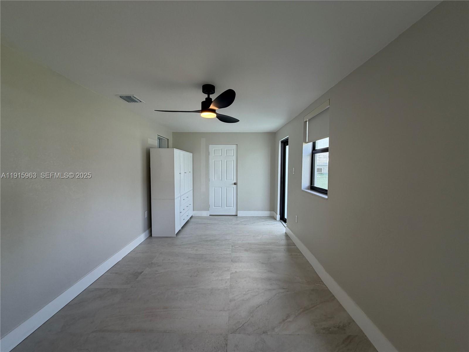 7330 Southwest 11th Street, Unit EFFICIENCY Miami, FL 33144 - Photo 10 of 11 a view of empty room with windows