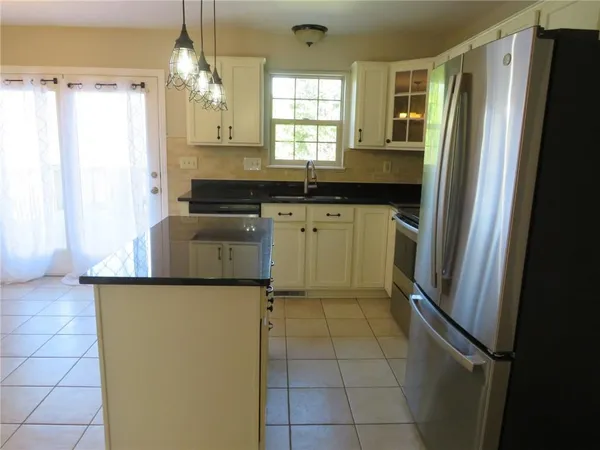 a kitchen with a refrigerator and a sink
