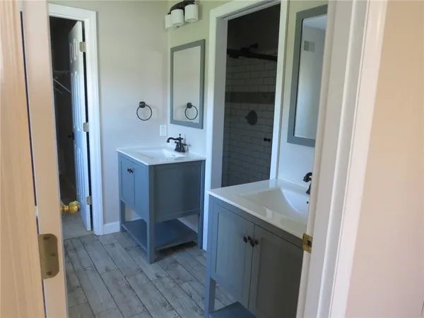 a bathroom with a sink a mirror and a shower