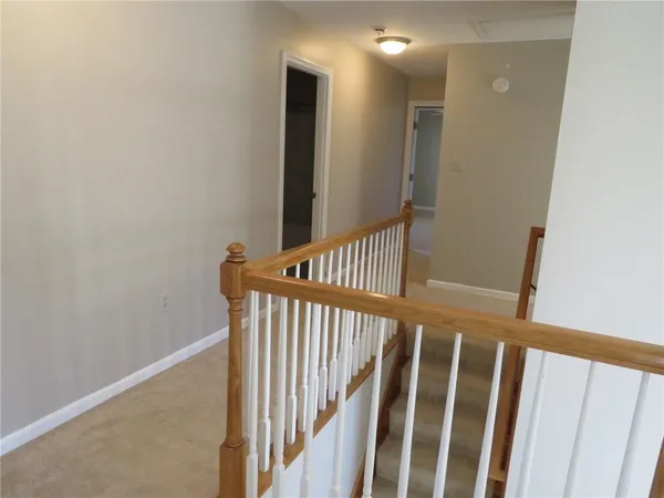 a view of staircase with railing and a window
