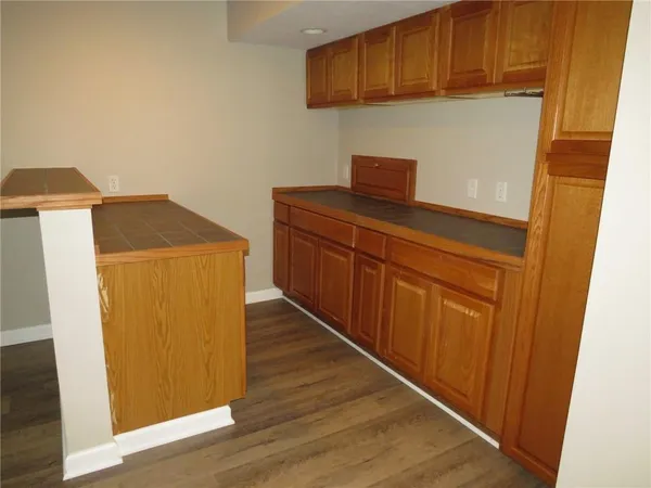 a kitchen with a refrigerator and cabinets