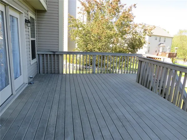 a balcony with wooden floor and fence