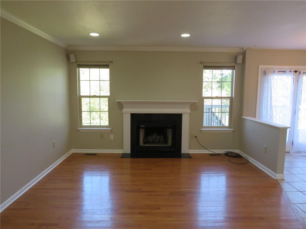 6755 Old Mars Crider Road Seven Fields, PA 16046 - Photo 7 of 50 an empty room with wooden floor fireplace and windows