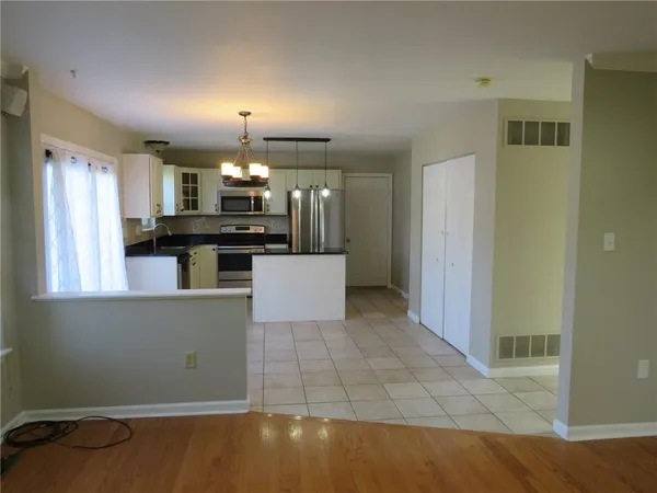 a kitchen with granite countertop a stove and a refrigerator