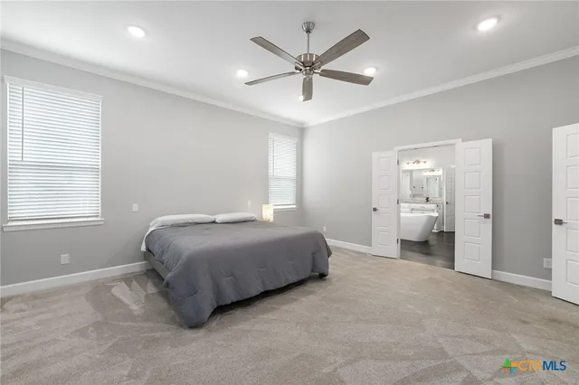 a bedroom with a bed and a ceiling fan