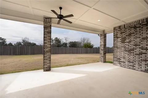 a view of a road with wooden fence