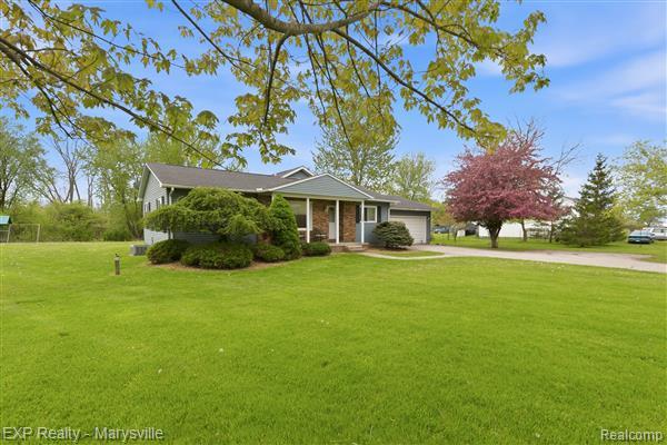 12265 Hough Road Memphis, MI 48041 - Photo 3 of 41 Single story home featuring a porch, a garage, driveway, and a front yard