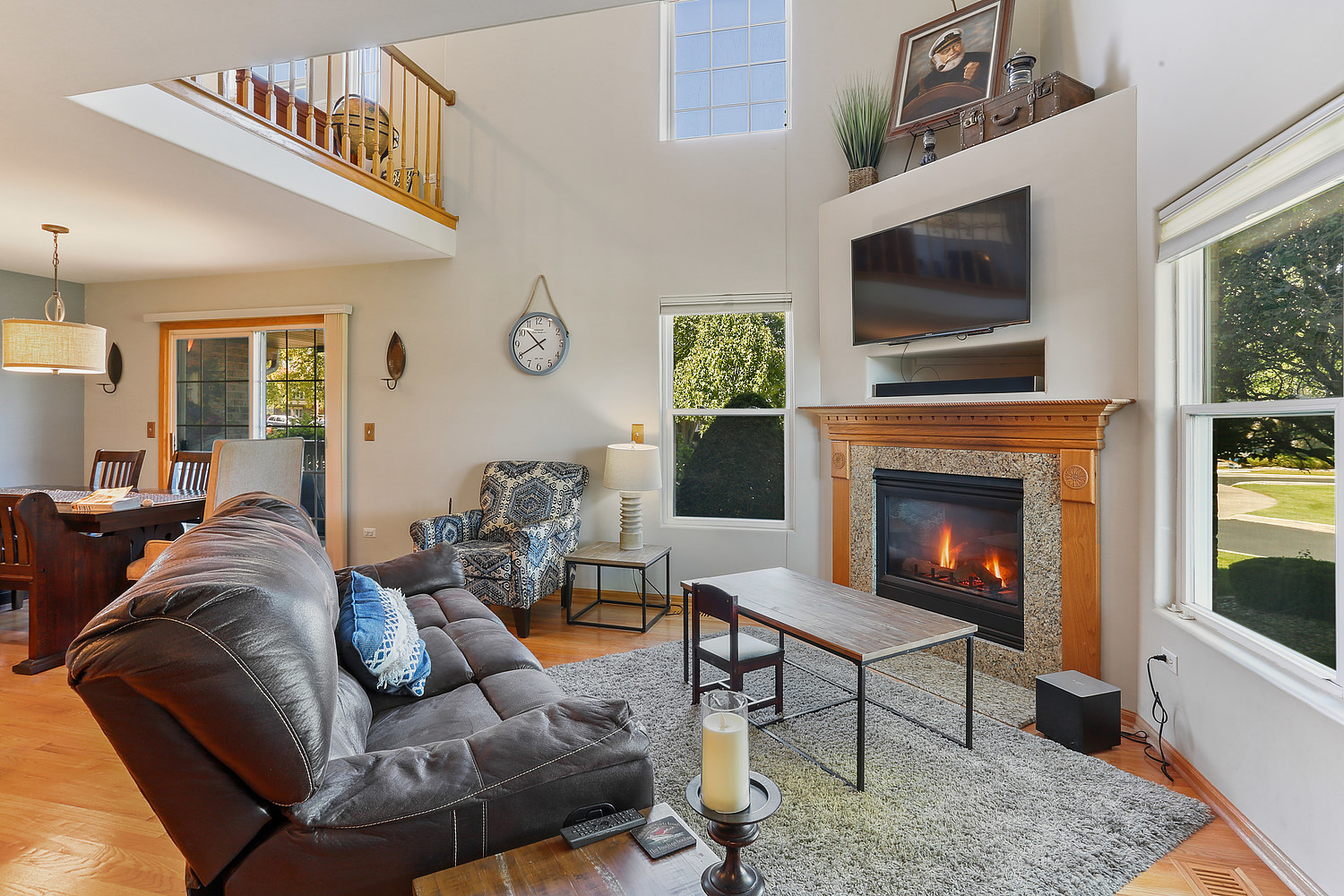 18133 Eagle Drive Tinley Park, IL 60477 - Photo 2 of 20 a living room with furniture a flat screen tv and a fireplace