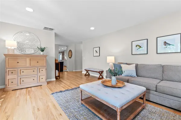 a living room with gym equipment and a wooden floor