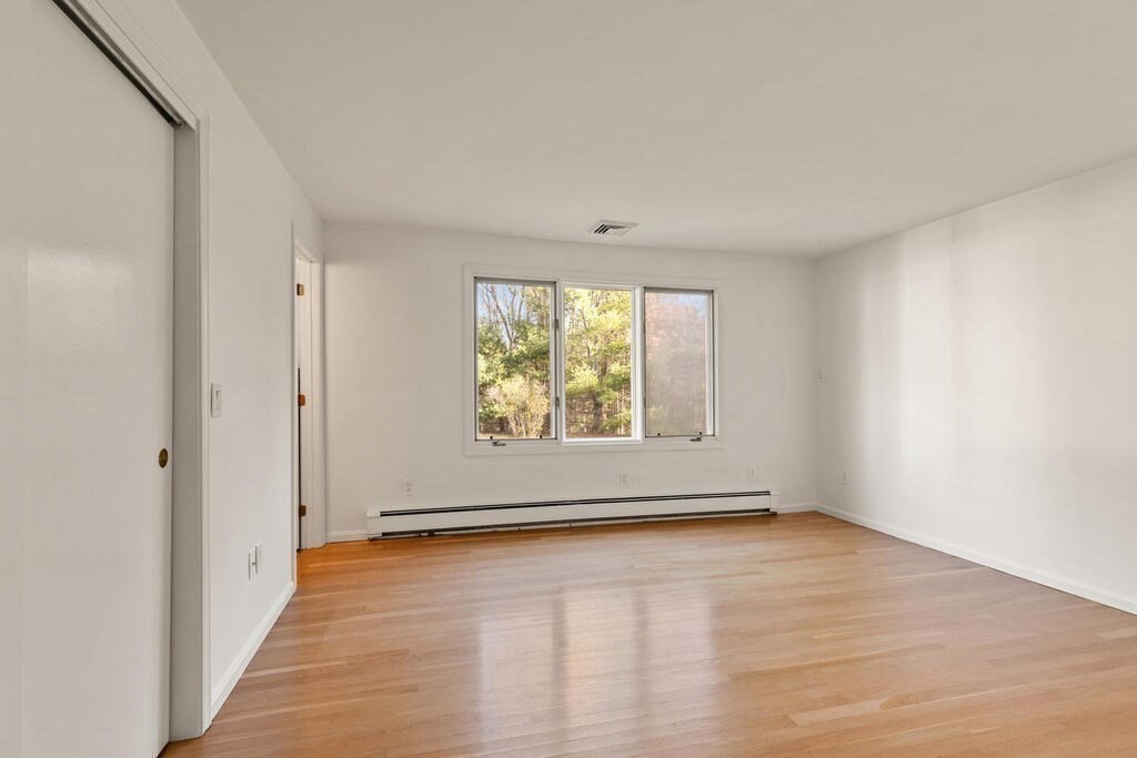 815 Great Road Stow, MA 01775 - Photo 20 of 32 wooden floor in an empty room with a window