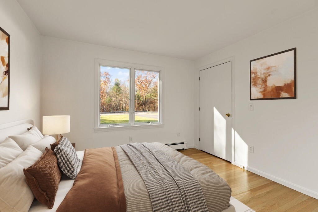 815 Great Road Stow, MA 01775 - Photo 23 of 32 a bedroom with a bed and a painting on the wall