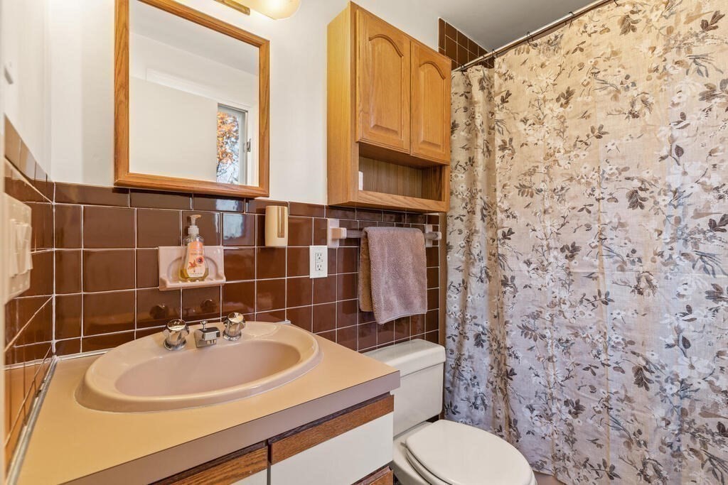 815 Great Road Stow, MA 01775 - Photo 25 of 32 a bathroom with a sink a toilet and a mirror