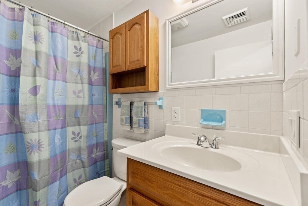 815 Great Road Stow, MA 01775 - Photo 26 of 32 a bathroom with a sink toilet vanity and shower