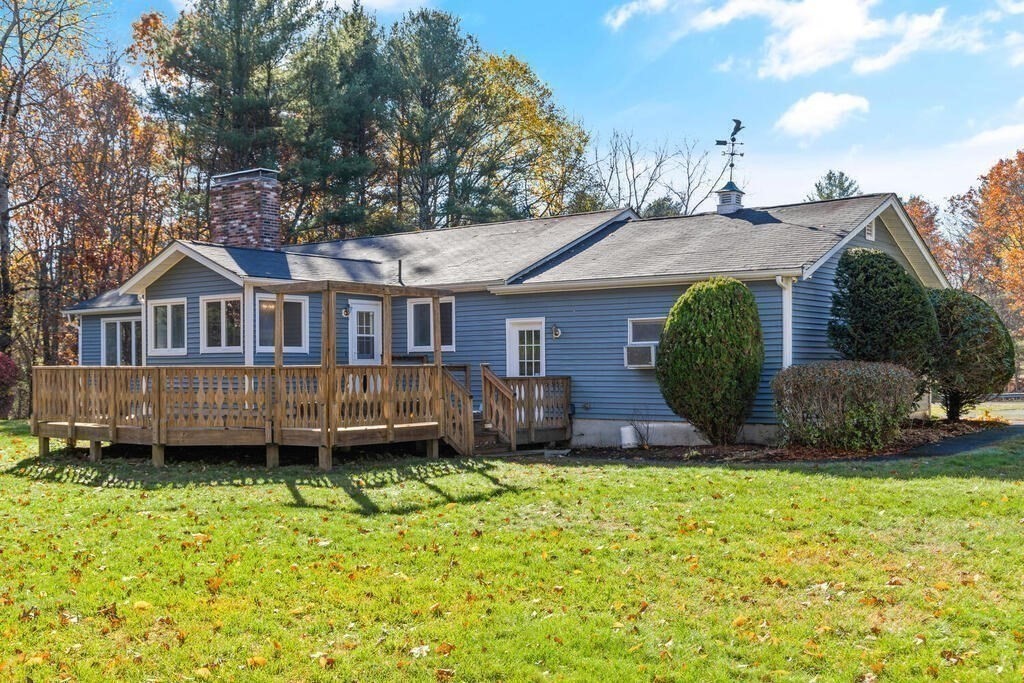 815 Great Road Stow, MA 01775 - Photo 27 of 32 a view of a house with a yard and sitting area