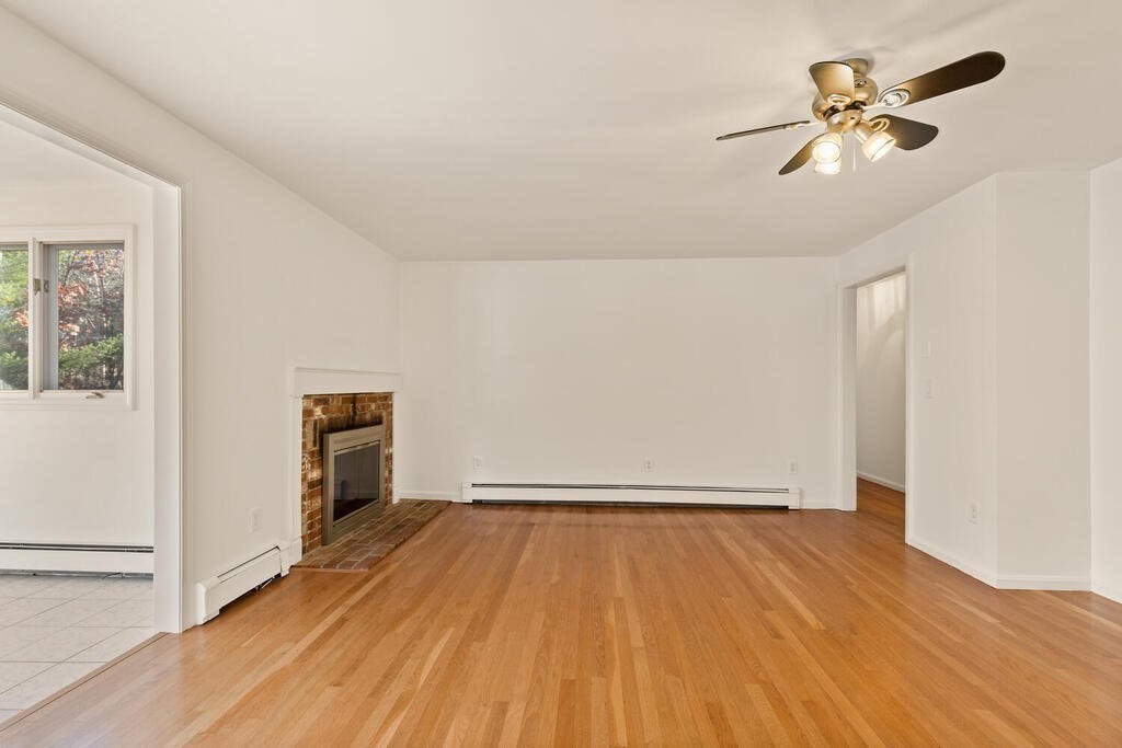 815 Great Road Stow, MA 01775 - Photo 10 of 32 a view of empty room with wooden floor
