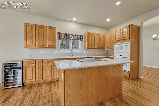 a kitchen with sink cabinets and wooden floor