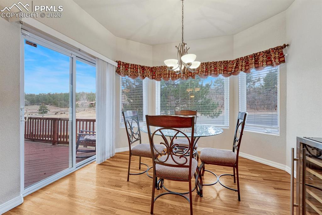 1665 Doe Run Point Colorado Springs, CO 80919 - Photo 15 of 49 a view of a dining room with furniture window and wooden floor