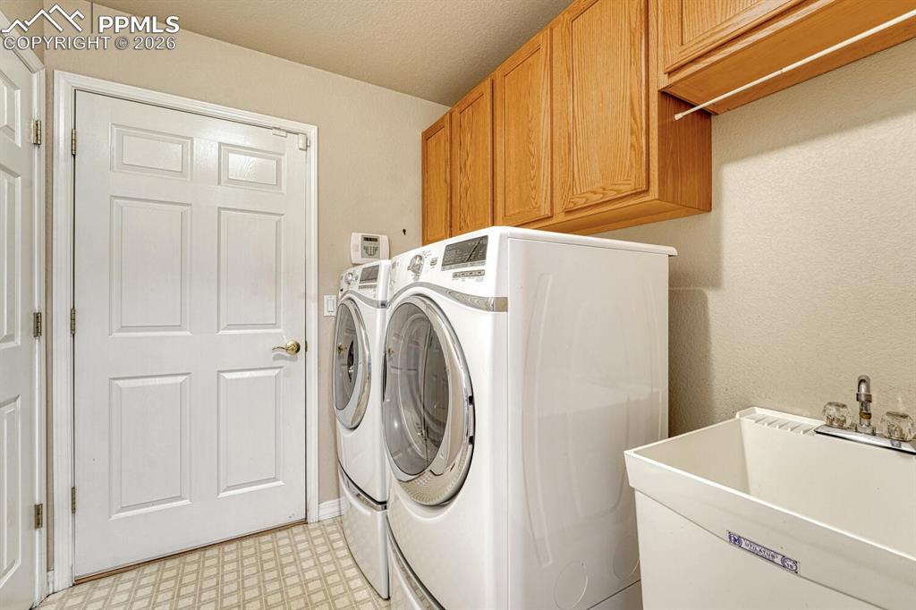 1665 Doe Run Point Colorado Springs, CO 80919 - Photo 28 of 49 a utility room with dryer and washer