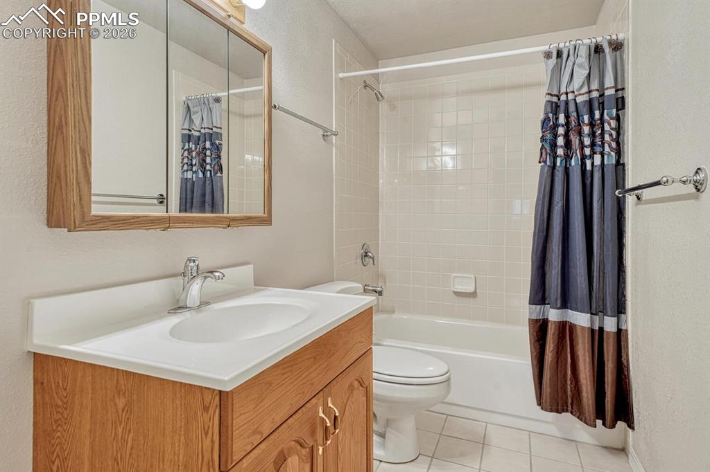1665 Doe Run Point Colorado Springs, CO 80919 - Photo 35 of 49 a bathroom with a sink toilet and shower