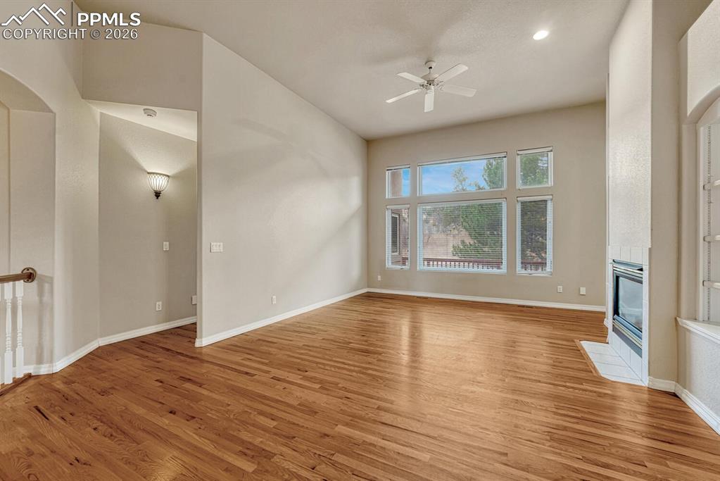 1665 Doe Run Point Colorado Springs, CO 80919 - Photo 5 of 49 a view of an empty room with wooden floor and a window