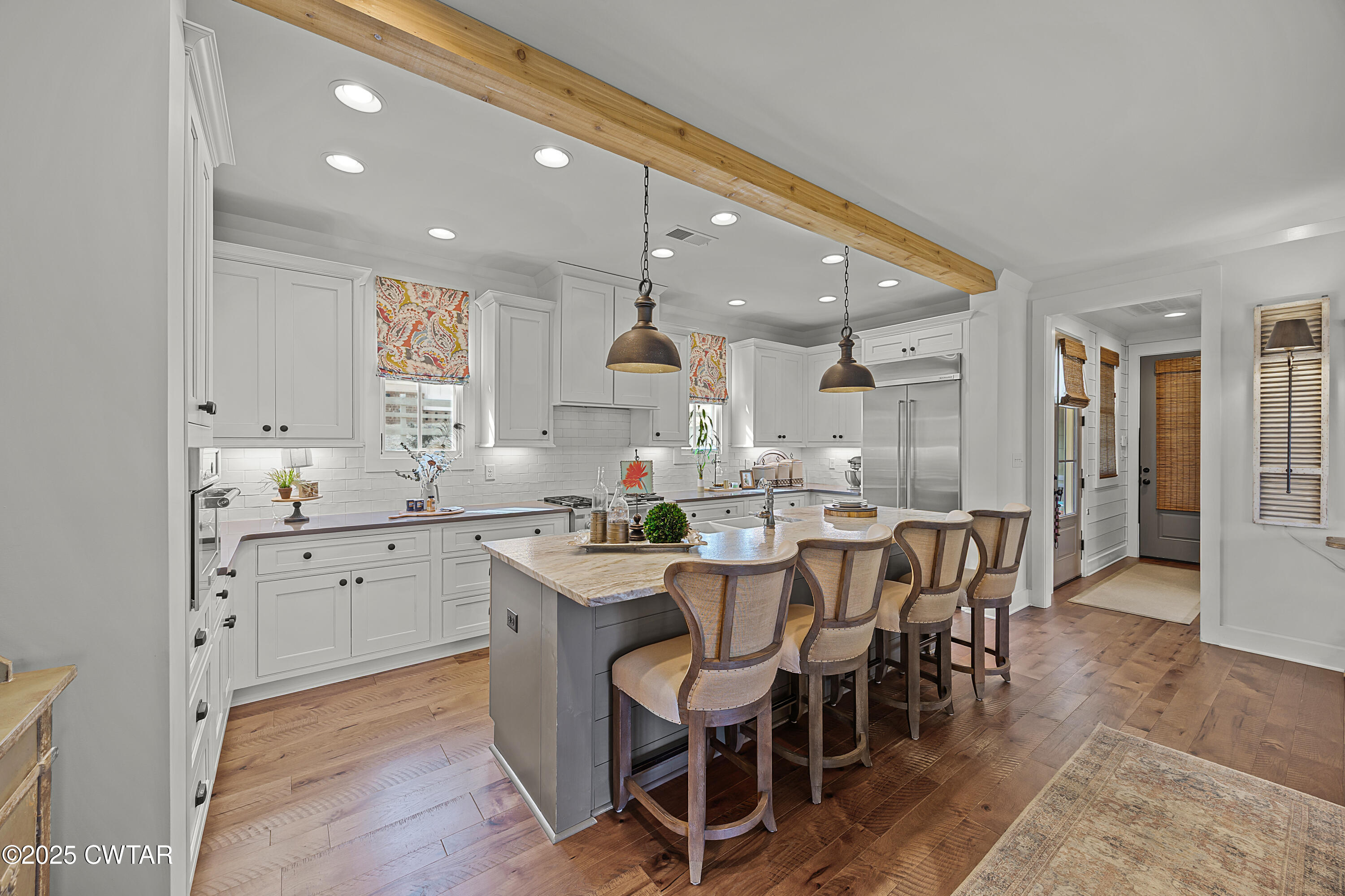 101 Morgan Street Jackson, TN 38301 - Photo 13 of 24 a kitchen with a dining table chairs stainless steel appliances and cabinets