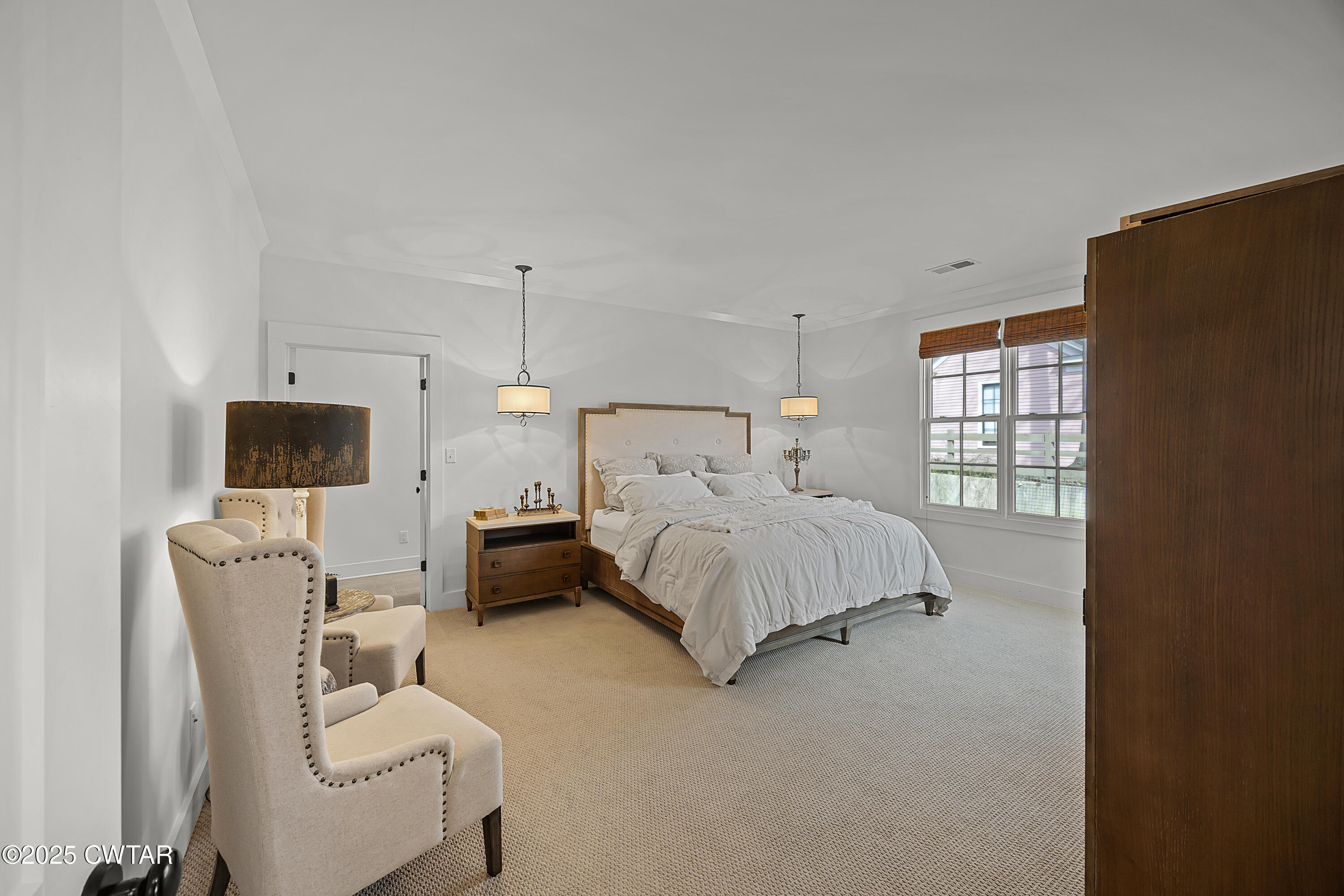 101 Morgan Street Jackson, TN 38301 - Photo 18 of 24 a bedroom with a bed a flat screen tv and windows