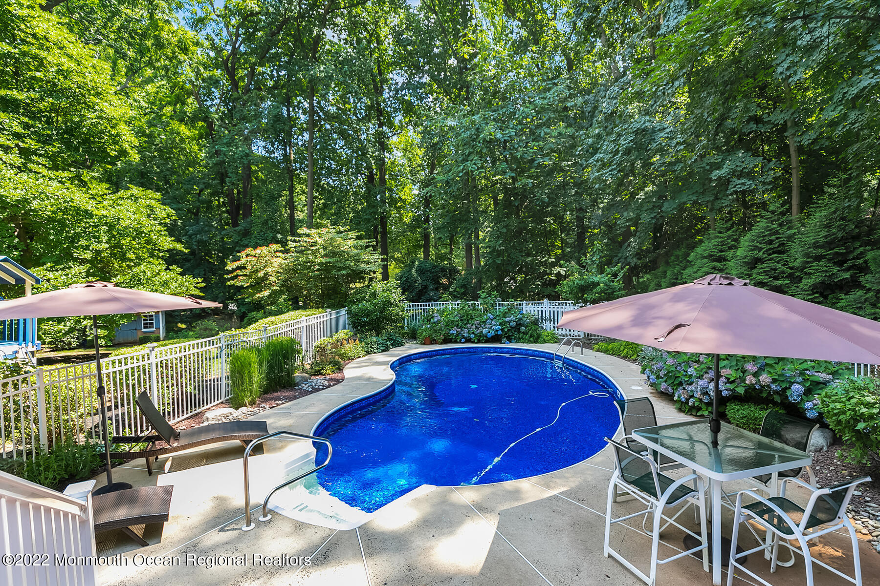 234 Red Hill Road Middletown, NJ 07748 - Photo 34 of 58 a view of a chairs and table under an umbrella
