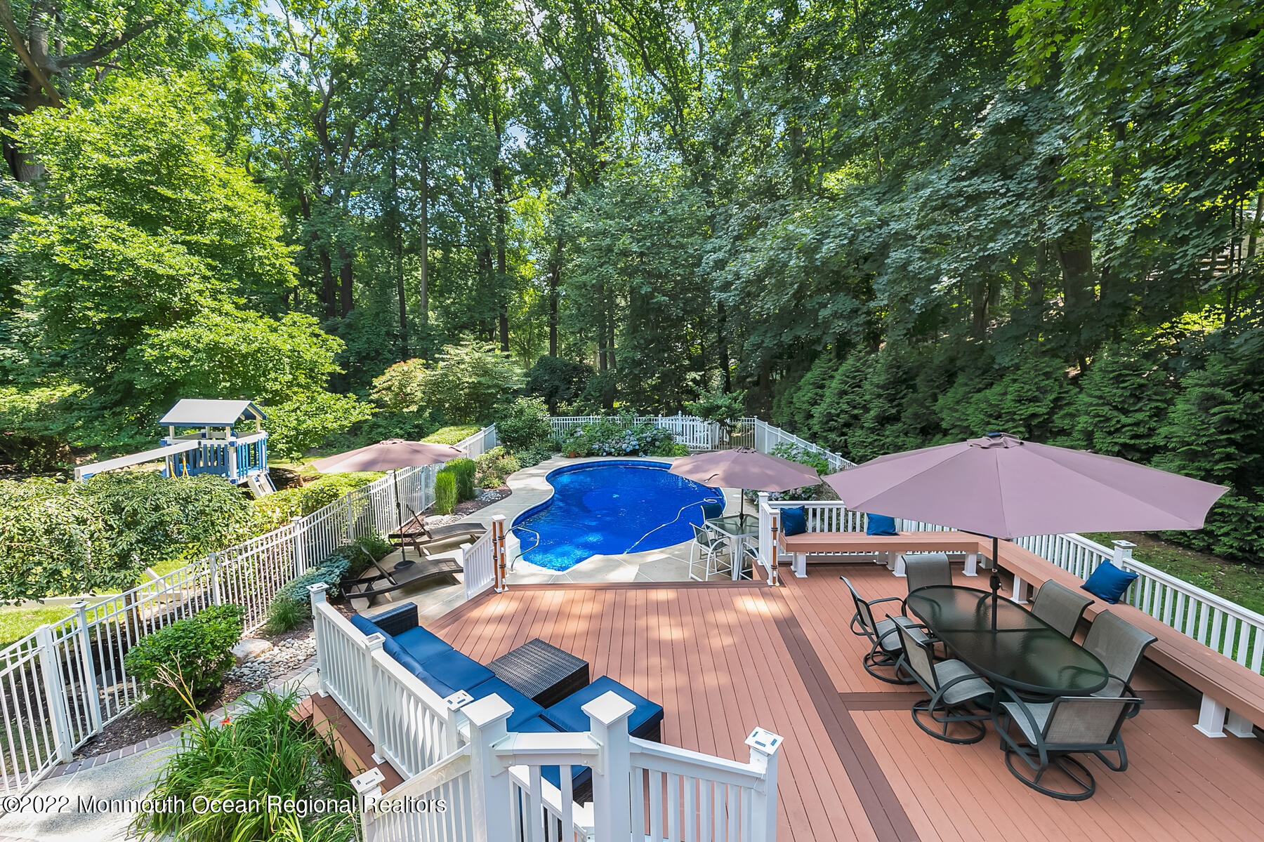 234 Red Hill Road Middletown, NJ 07748 - Photo 38 of 58 a view of a patio with table and chairs potted plants with wooden floor and fence