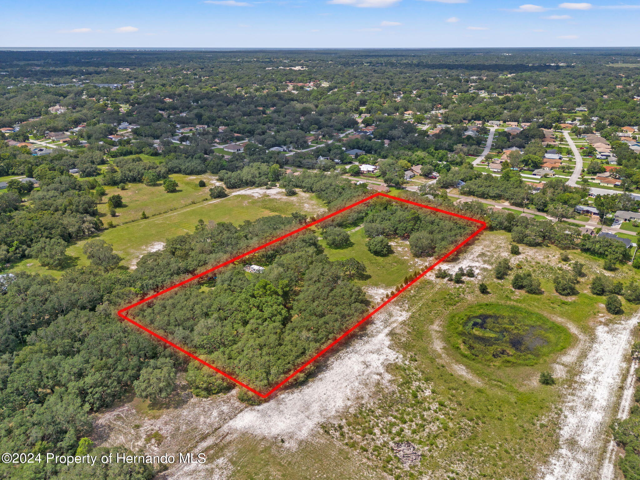 1088 Newcomb Avenue Spring Hill, FL 34608 - Photo 3 of 9 an aerial view of residential houses with outdoor space and trees