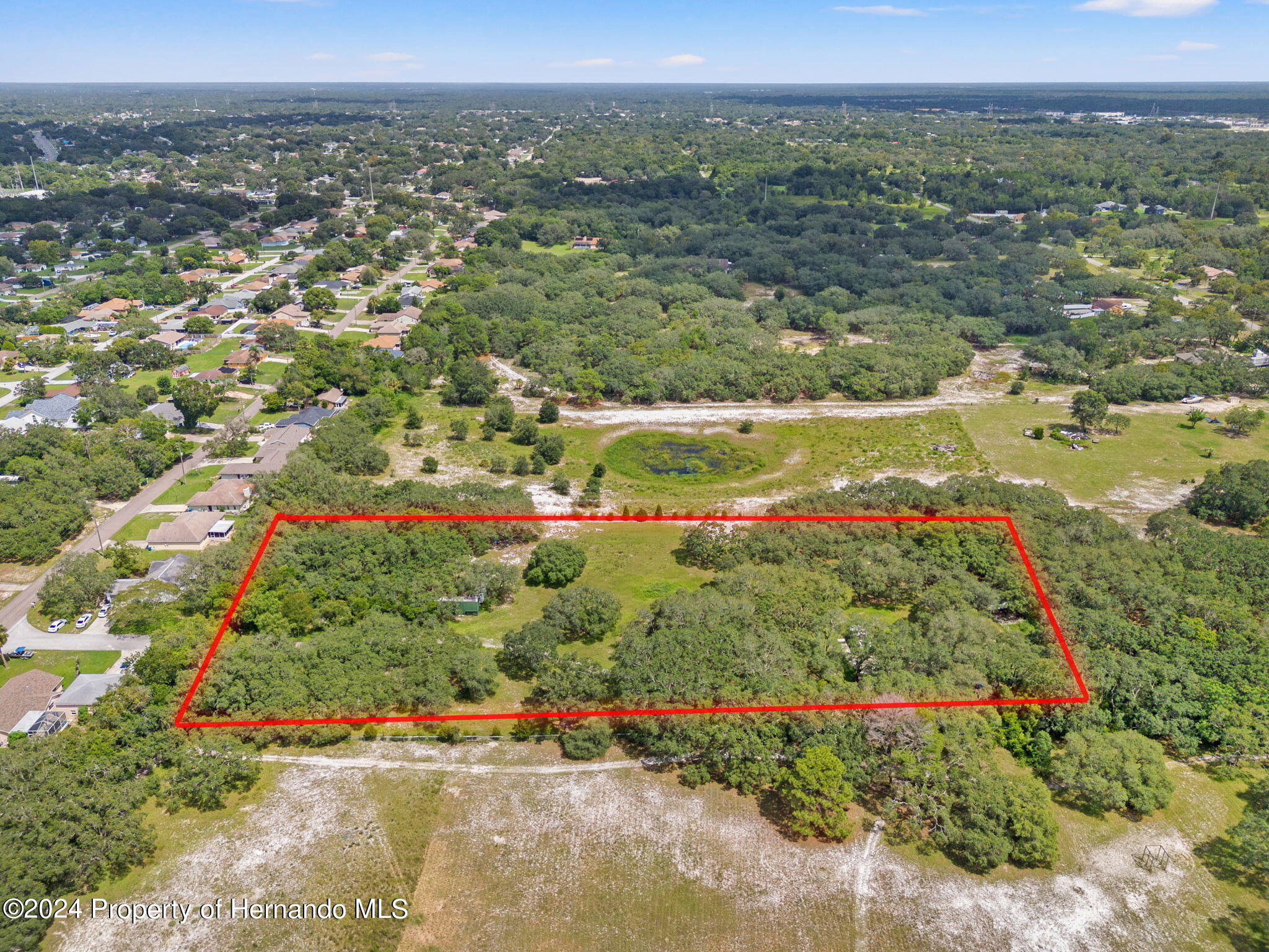 1088 Newcomb Avenue Spring Hill, FL 34608 - Photo 6 of 9 an aerial view of residential houses with outdoor space and trees
