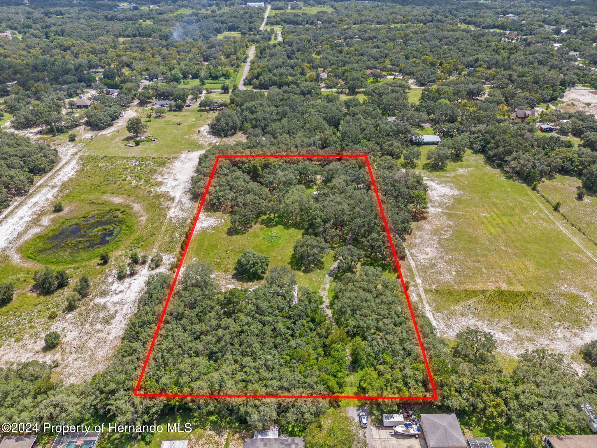 1088 Newcomb Avenue Spring Hill, FL 34608 - Photo 8 of 9 a view of a lake with a flower garden