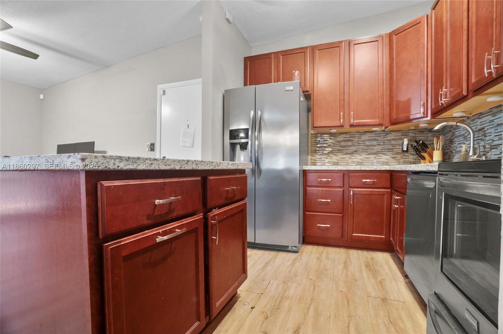 9606 West McNab Road, Unit 202 Tamarac, FL 33321 - Photo 12 of 29 a kitchen with stainless steel appliances granite countertop a refrigerator a stove and a sink