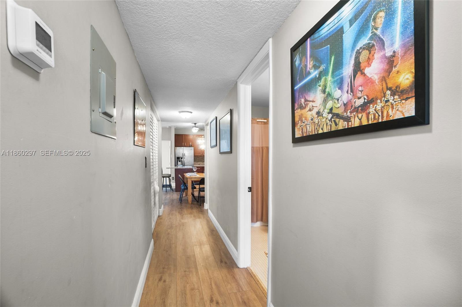 9606 West McNab Road, Unit 202 Tamarac, FL 33321 - Photo 16 of 29 a view of a hallway with wooden floor and a painting