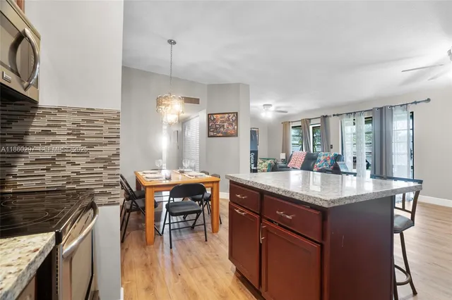 a kitchen with stainless steel appliances granite countertop a sink stove and cabinets