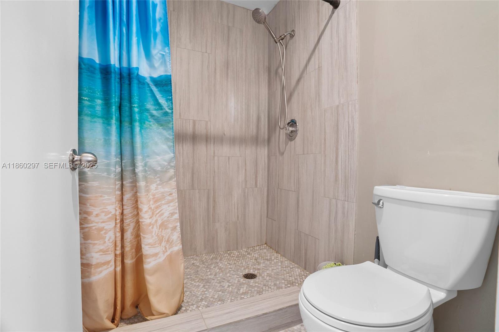 9606 West McNab Road, Unit 202 Tamarac, FL 33321 - Photo 21 of 29 a white toilet sitting next to a shower