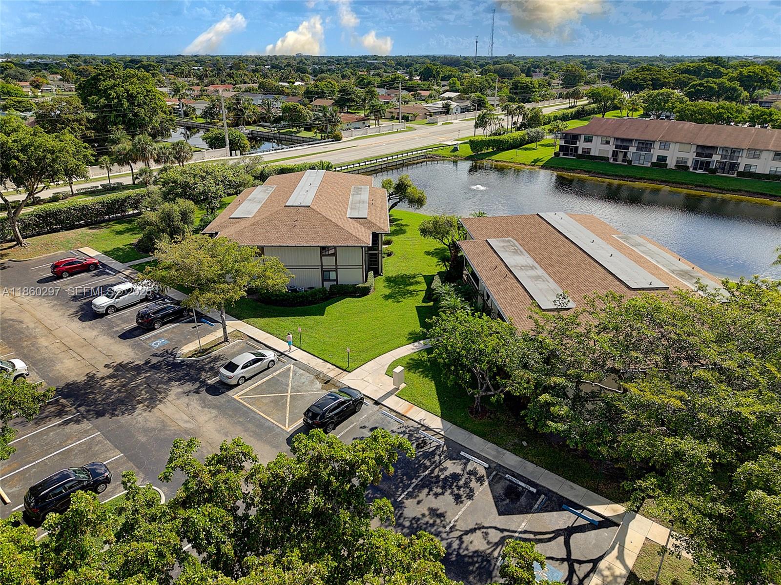 9606 West McNab Road, Unit 202 Tamarac, FL 33321 - Photo 23 of 29 an aerial view of a house with a garden and lake view