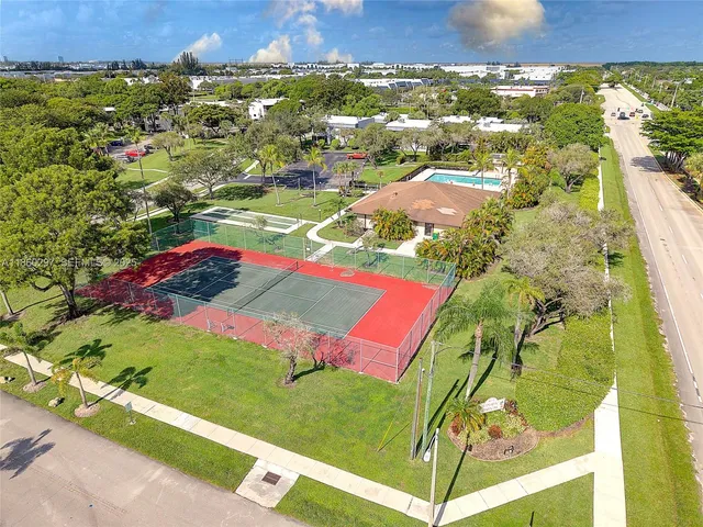 an aerial view of a residential houses with outdoor space
